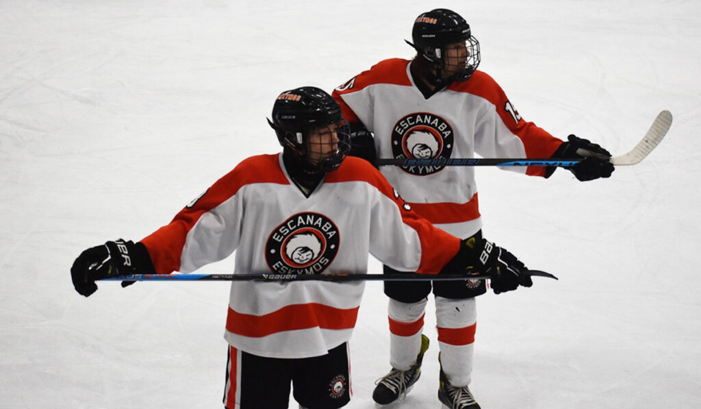 Escanaba hockey freshmen Nolan Bink and Graham Johnson stand side by side on the ice.