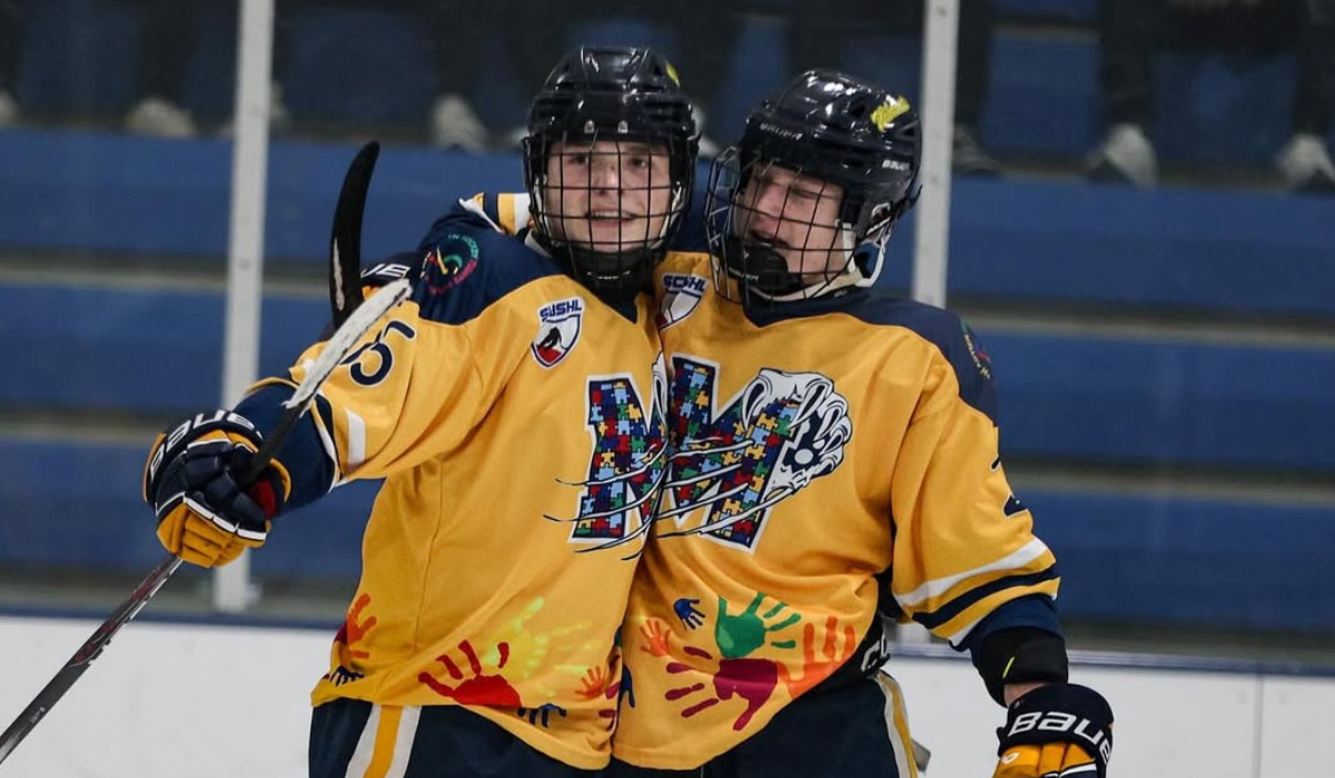 Brayden Lewis and Ben Edington celebrate on the ice after scoring a goal for Mattawan hockey.
