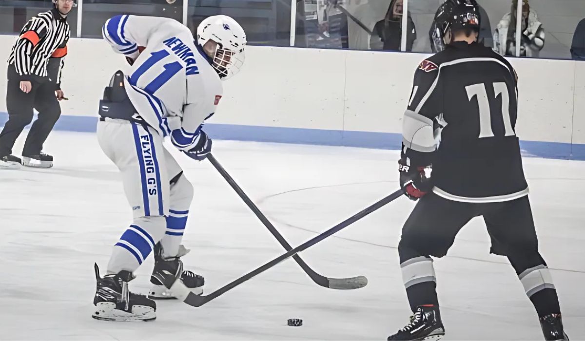 Clayton Newman skates with the puck in a Michigan high school hockey game for Gladwin hockey.