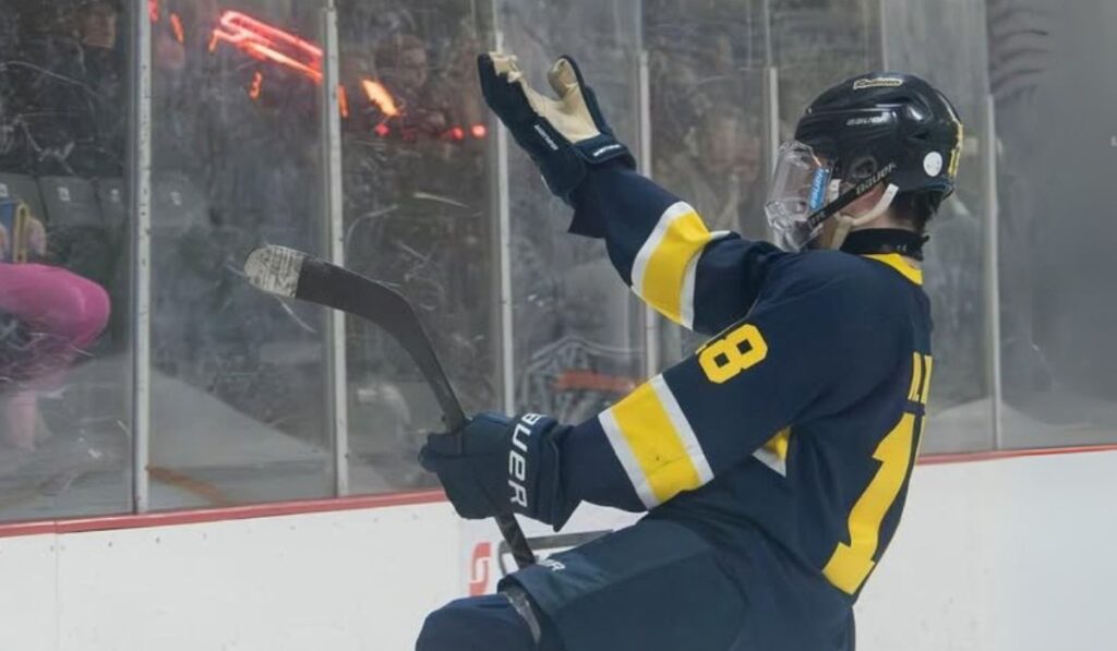 Nolan Hizer celebrates after scoring a goal for Rochester United hockey