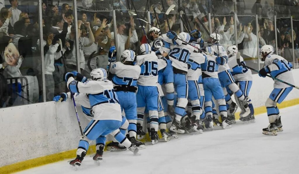 Livonia Stevenson hockey rushes the ice and jumps into the glass celebrating in front of the student section.