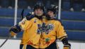 Brayden Lewis and Ben Edington celebrate on the ice after scoring a goal for Mattawan hockey.