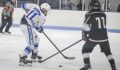 Clayton Newman skates with the puck in a Michigan high school hockey game for Gladwin hockey.